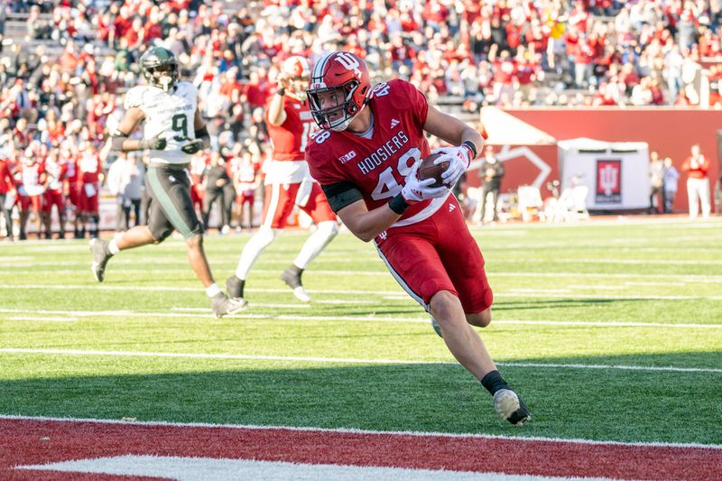 Nov 18, 2023; Bloomington, Indiana, USA; Indiana Hoosiers tight end James Bomba (48) runs the ball in to the end zone for a touchdown doing gate second half against the Michigan State Spartans at Memorial Stadium. Mandatory Credit: Marc Lebryk-USA TODAY Sports