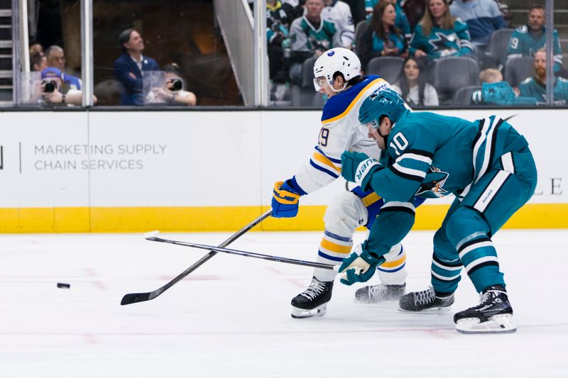 Nov 23, 2024; San Jose, California, USA; San Jose Sharks center Klim Kostin (10) defends Buffalo Sabres center Peyton Krebs (19) during the first period at SAP Center in San Jose. Mandatory Credit: John Hefti-Imagn Images