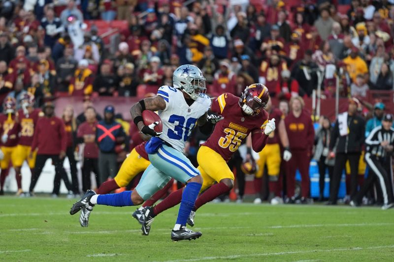 Dallas Cowboys safety Juanyeh Thomas (30) celebrates after scoring a 43-yard touchdown off a kickoff return during the second half of an NFL football game against the Washington Commanders, Sunday, Nov. 24, 2024, in Landover, Md. (AP Photo/Stephanie Scarbrough)