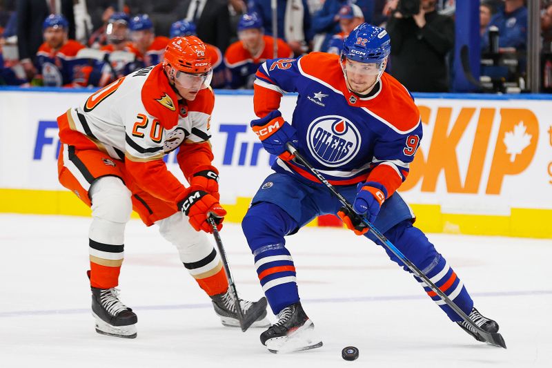 Jan 3, 2025; Edmonton, Alberta, CAN; Edmonton Oilers forward Vasily Podkolzin (92) protects the puck from Anaheim Ducks forward Brett Leason (20) during the third period at Rogers Place. Mandatory Credit: Perry Nelson-Imagn Images