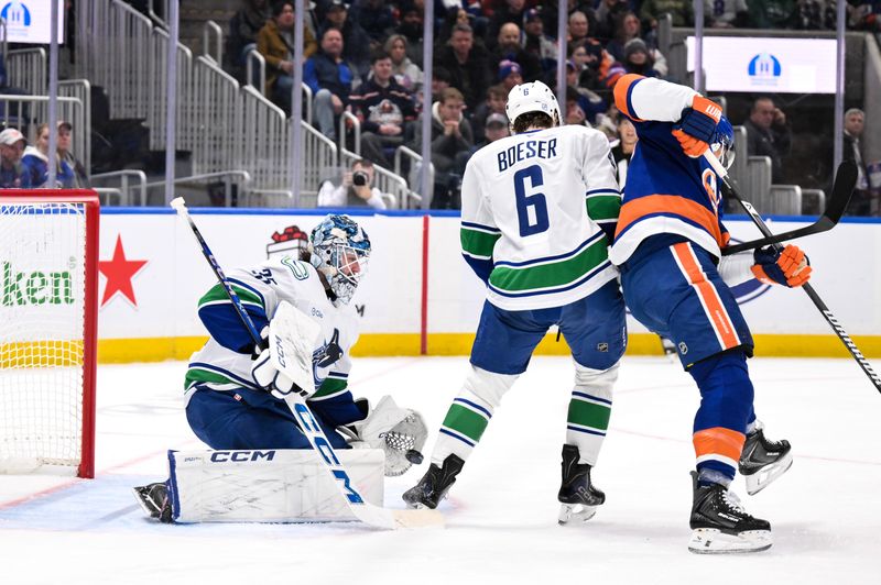 Dec 19, 2025; Elmont, New York, USA; Vancouver Canucks goaltender Thatcher Demko (35) makes a save against the New York Islanders during the second period at UBS Arena. Mandatory Credit: John Jones-Imagn Images