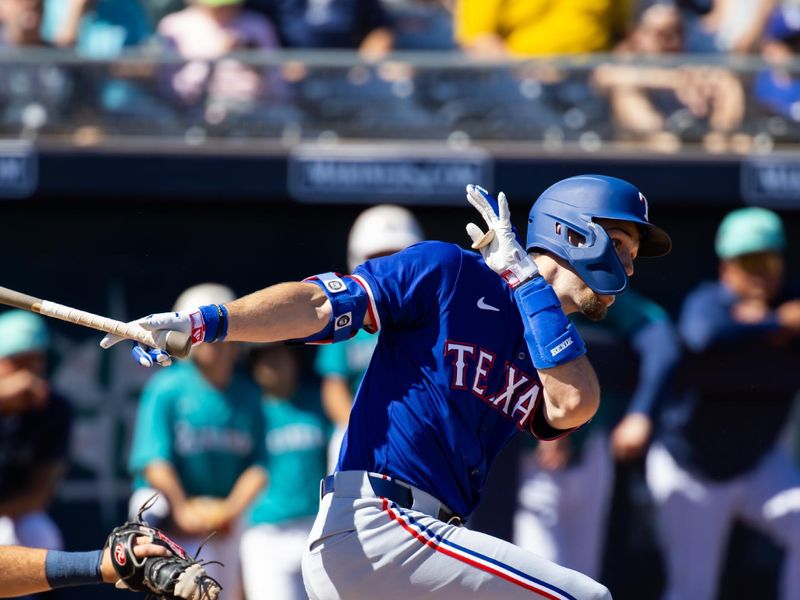 Mar 5, 2024; Peoria, Arizona, USA; Texas Rangers outfielder Evan Carter hits a home run against the Seattle Mariners during a spring training baseball game at Peoria Sports Complex. Mandatory Credit: Mark J. Rebilas-USA TODAY Sports