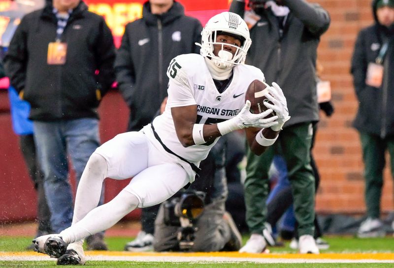 Oct 28, 2023; Minneapolis, Minnesota, USA;  Michigan State Spartans wide receiver Jaron Glover (15) catches a pass against the Minnesota Golden Gophers during the fourth quarter at Huntington Bank Stadium. Mandatory Credit: Nick Wosika-USA TODAY Sports