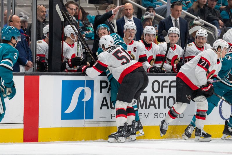 Nov 27, 2024; San Jose, California, USA; Ottawa Senators left wing Cole Reinhardt (51) and San Jose Sharks right wing Barclay Goodrow (23) start a fight during the first period in front of the bench at SAP Center at San Jose. Mandatory Credit: Neville E. Guard-Imagn Images