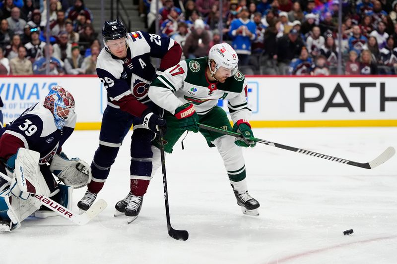 Jan 20, 2025; Denver, Colorado, USA; Colorado Avalanche goaltender Mackenzie Blackwood (39) and center Nathan MacKinnon (29) defend on Minnesota Wild left wing Marcus Foligno (17) in the first period at Ball Arena. Mandatory Credit: Ron Chenoy-Imagn Images