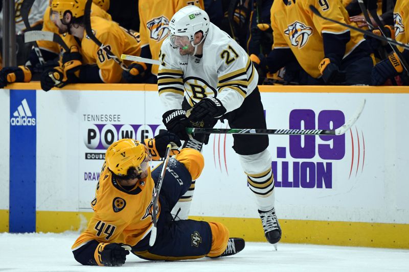 Apr 2, 2024; Nashville, Tennessee, USA; Boston Bruins left wing James van Riemsdyk (21) hits Nashville Predators left wing Kiefer Sherwood (44) during the second period at Bridgestone Arena. Mandatory Credit: Christopher Hanewinckel-USA TODAY Sports