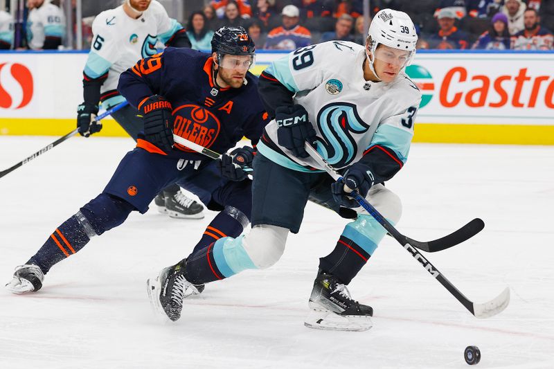 Jan 18, 2024; Edmonton, Alberta, CAN; Seattle Kraken defensemen Ryker Evans (39) looks to make a pass in front of Edmonton Oilers forward Leon Draisaitl (29) during the first period at Rogers Place. Mandatory Credit: Perry Nelson-USA TODAY Sports