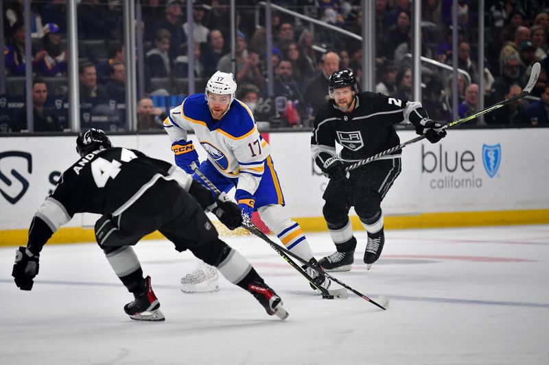 Feb 13, 2023; Los Angeles, California, USA; Buffalo Sabres center Tyson Jost (17) moves the puck against Los Angeles Kings defenseman Mikey Anderson (44) and defenseman Alexander Edler (2) during the first period at Crypto.com Arena. Mandatory Credit: Gary A. Vasquez-USA TODAY Sports