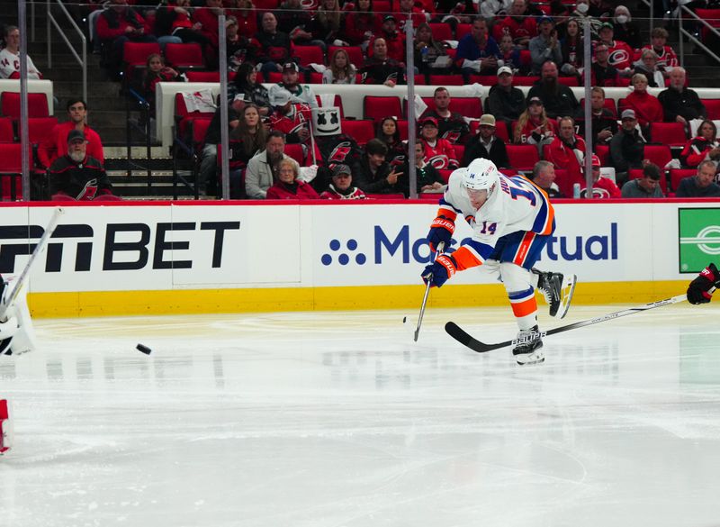 Apr 22, 2024; Raleigh, North Carolina, USA; New York Islanders center Bo Horvat (14) shoots against the Carolina Hurricanes during the second period in game two of the first round of the 2024 Stanley Cup Playoffs at PNC Arena. Mandatory Credit: James Guillory-USA TODAY Sports