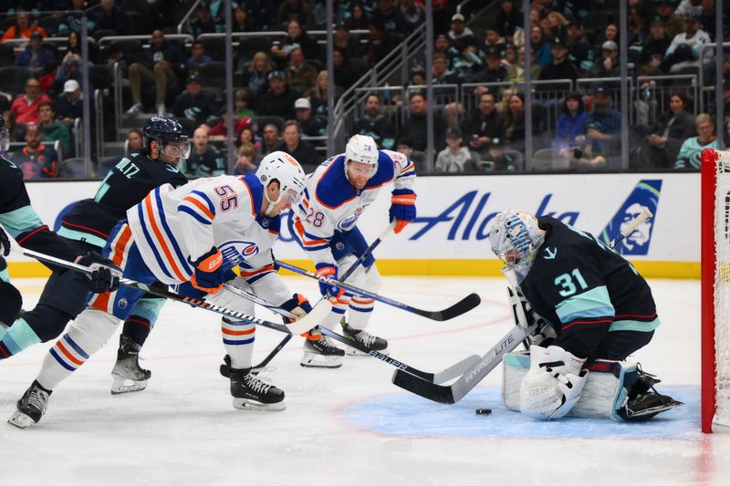 Mar 2, 2024; Seattle, Washington, USA; Seattle Kraken goaltender Philipp Grubauer (31) blocks a goal shot by Edmonton Oilers left wing Dylan Holloway (55) during the third period at Climate Pledge Arena. Mandatory Credit: Steven Bisig-USA TODAY Sports