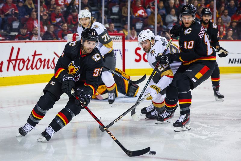 Mar 14, 2024; Calgary, Alberta, CAN; Calgary Flames center Nazem Kadri (91) controls the puck against the Vegas Golden Knights during the first period at Scotiabank Saddledome. Mandatory Credit: Sergei Belski-USA TODAY Sports