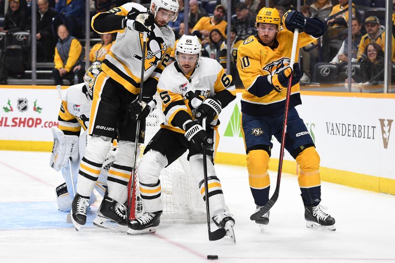 Nov 28, 2023; Nashville, Tennessee, USA; Pittsburgh Penguins defenseman Erik Karlsson (65) plays the puck before pressure from Nashville Predators center Colton Sissons (10) during the first period at Bridgestone Arena. Mandatory Credit: Christopher Hanewinckel-USA TODAY Sports