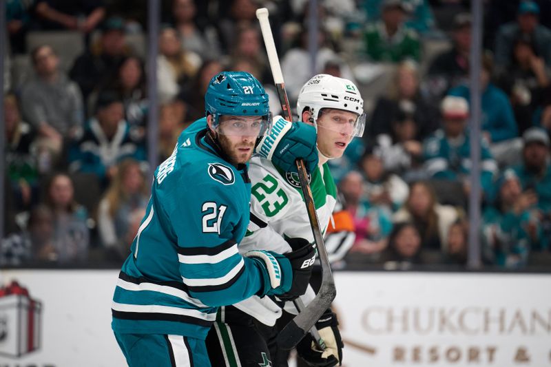 Dec 18, 2025; San Jose, California, USA; San Jose Sharks center Alexander Wennberg (21) vies for position against Dallas Stars defenseman Esa Lindell (23) during the second period at SAP Center at San Jose. Mandatory Credit: Robert Edwards-Imagn Images