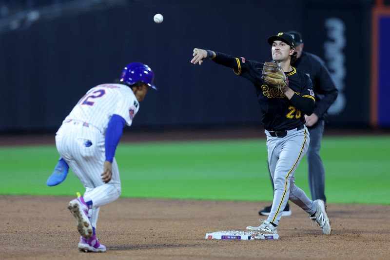 May 14, 2025; New York City, New York, USA; Pittsburgh Pirates second baseman Adam Frazier (26) forces out New York Mets shortstop Francisco Lindor (12) at second then throws to first to complete a double play on a ball hit by third baseman Mark Vientos (not pictured) during the third inning at Citi Field. Mandatory Credit: Brad Penner-Imagn Images