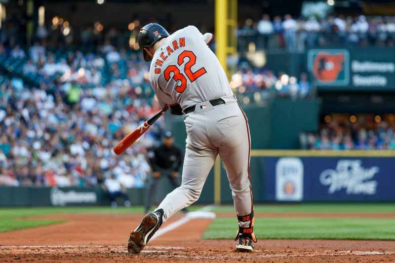 Jul 3, 2024; Seattle, Washington, USA; Baltimore Orioles first baseman Ryan O'Hearn (32) hits a two-run double against the Seattle Mariners during the third inning at T-Mobile Park. Mandatory Credit: Joe Nicholson-USA TODAY Sports
