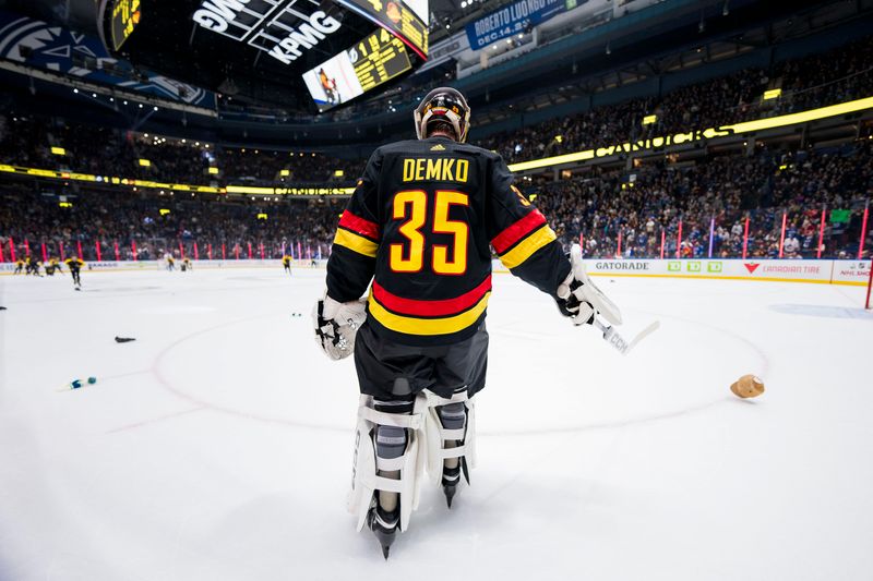 Dec 12, 2023; Vancouver, British Columbia, CAN; Vancouver Canucks goalie Thatcher Demko (35) forward Brock Boeser   s (6) third goal of the game by cleaning up thrown hats on the ice against the Tampa Bay Lightning in the third period at Rogers Arena. Vancouver won 4-1. Mandatory Credit: Bob Frid-USA TODAY Sports