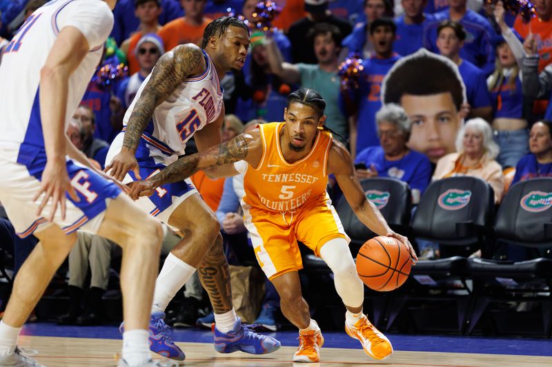 Jan 7, 2025; Gainesville, Florida, USA; Tennessee Volunteers guard Zakai Zeigler (5) dribbles the ball away from Florida Gators guard Alijah Martin (15) during the first half at Exactech Arena at the Stephen C. O'Connell Center. Mandatory Credit: Matt Pendleton-Imagn Images