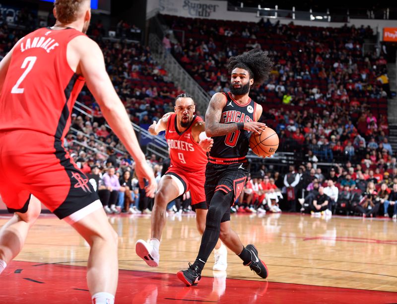 HOUSTON, TX - MARCH 21:   Coby White #0 of the Chicago Bulls drives to the basket during the game as Dillon Brooks #9 of the Houston Rockets plays defense on March 21, 2024 at the Toyota Center in Houston, Texas. NOTE TO USER: User expressly acknowledges and agrees that, by downloading and or using this photograph, User is consenting to the terms and conditions of the Getty Images License Agreement. Mandatory Copyright Notice: Copyright 2024 NBAE (Photo by Logan Riely/NBAE via Getty Images)