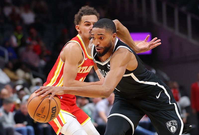 ATLANTA, GEORGIA - DECEMBER 06:  Mikal Bridges #1 of the Brooklyn Nets drives against Trae Young #11 of the Atlanta Hawks during the fourth quarter at State Farm Arena on December 06, 2023 in Atlanta, Georgia.  NOTE TO USER: User expressly acknowledges and agrees that, by downloading and/or using this photograph, user is consenting to the terms and conditions of the Getty Images License Agreement.  (Photo by Kevin C. Cox/Getty Images)