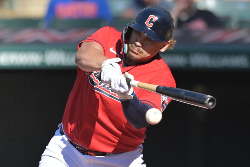 Jun 24, 2023; Cleveland, Ohio, USA; Cleveland Guardians first baseman Josh Naylor (22) hits an RBI single during the sixth inning against the Milwaukee Brewers at Progressive Field. Mandatory Credit: Ken Blaze-USA TODAY Sports