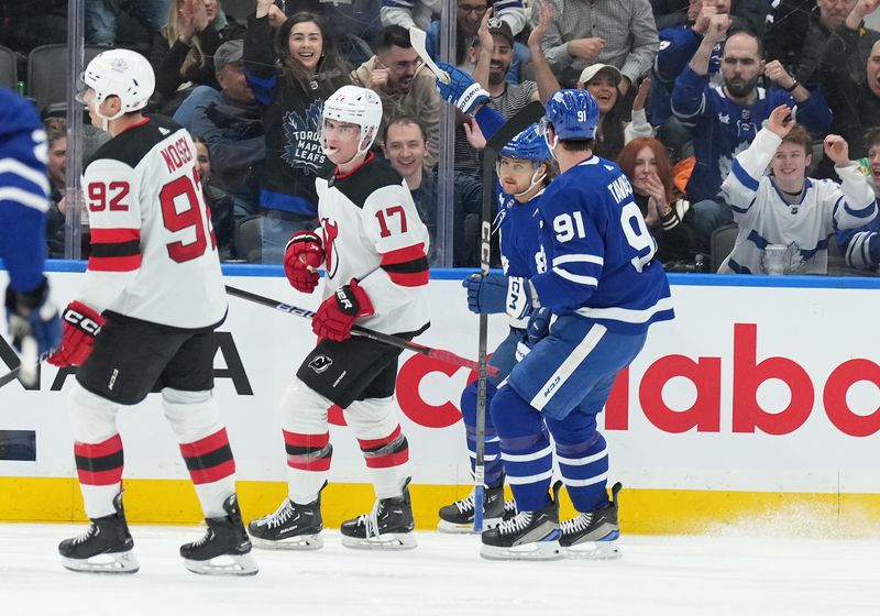 Mar 26, 2024; Toronto, Ontario, CAN; Toronto Maple Leafs right wing William Nylander (88) scores a goal and celebrates with center John Tavares (91) against the New Jersey Devils during the second period at Scotiabank Arena. Mandatory Credit: Nick Turchiaro-USA TODAY Sports