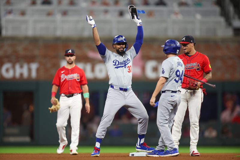 Sep 13, 2024; Atlanta, Georgia, USA; Los Angeles Dodgers left fielder Teoscar Hernandez (37) celebrates after a double against the Atlanta Braves in the fourth inning at Truist Park. Mandatory Credit: Brett Davis-Imagn Images