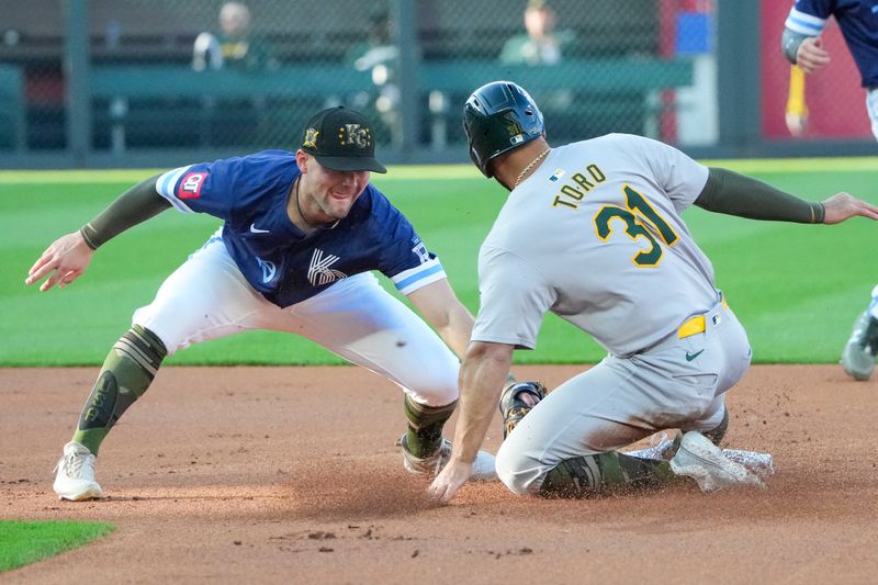 May 17, 2024; Kansas City, Missouri, USA; Kansas City Royals shortstop Bobby Witt Jr. (7) tags out Oakland Athletics left fielder Abraham Toro (31) trying to steal second base in the first inning at Kauffman Stadium. Mandatory Credit: Denny Medley-USA TODAY Sports