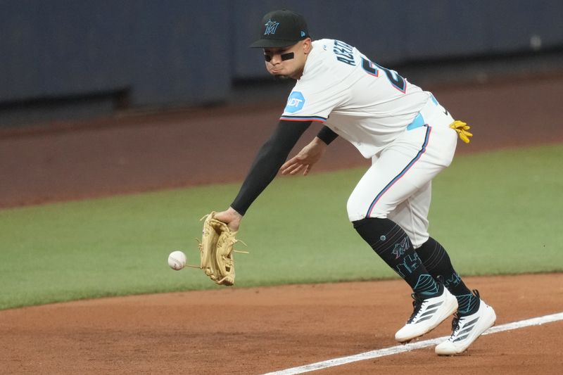 Sep 9, 2025; Miami, Florida, USA;  Miami Marlins third baseman Maximo Acosta (24) can’t handle a ground ball hit by Washington Nationals third baseman Brady House in the seventh inning at loanDepot Park. Mandatory Credit: Jim Rassol-Imagn Images