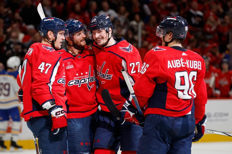 Nov 22, 2023; Washington, District of Columbia, USA; Washington Capitals defenseman Alexander Alexeyev (27) celebrates with teammates after scoring his first NHL goal, against the Buffalo Sabres, in the first period at Capital One Arena. Mandatory Credit: Geoff Burke-USA TODAY Sports