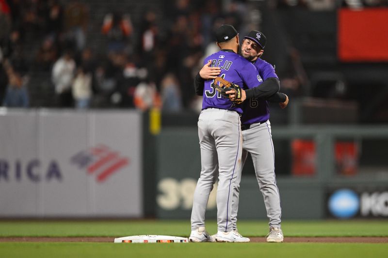 May 1, 2025; San Francisco, California, USA; Colorado Rockies second baseman Kyle Farmer (6) and shortstop Alan Trejo (31) celebrate their win over the San Francisco Giants in the ninth inning at Oracle Park. Mandatory Credit: Eakin Howard-Imagn Images
