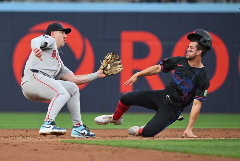 Jun 17, 2024; Toronto, Ontario, CAN;  Boston Red Sox second baseman Romy Gonzalez (23) prepares to tag out Toronto Blue Jays third baseman Ernie Clement (28) on an attempted steal of second base in the second inning at Rogers Centre. Mandatory Credit: Dan Hamilton-USA TODAY Sports