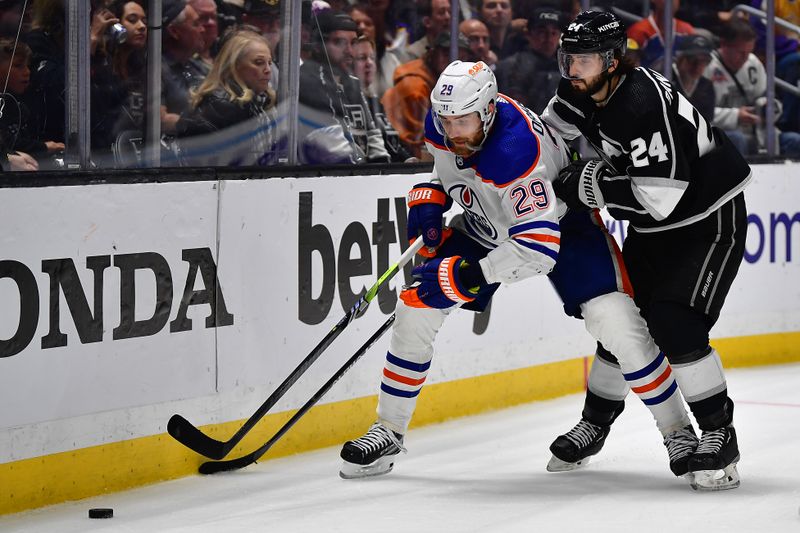 Apr 29, 2023; Los Angeles, California, USA; Edmonton Oilers center Leon Draisaitl (29) moves the puck against Los Angeles Kings center Phillip Danault (24) during the third period in game six of the first round of the 2023 Stanley Cup Playoffs at Crypto.com Arena. Mandatory Credit: Gary A. Vasquez-USA TODAY Sports