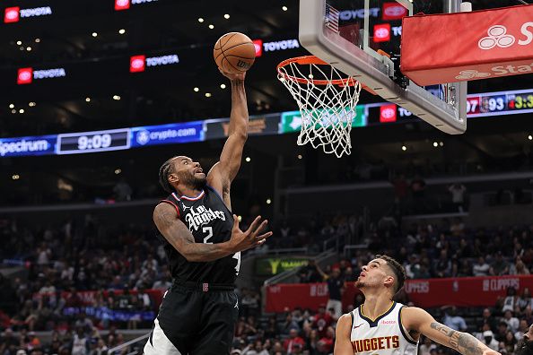 LOS ANGELES, CALIFORNIA - DECEMBER 06: Kawhi Leonard #2 of the Los Angeles Clippers dunks against Michael Porter Jr. #1 of the Denver Nuggets during the second half of a game at Crypto.com Arena on December 06, 2023 in Los Angeles, California. NOTE TO USER: User expressly acknowledges and agrees that, by downloading and or using this photograph, User is consenting to the terms and conditions of the Getty Images License Agreement.  (Photo by Michael Owens/Getty Images)