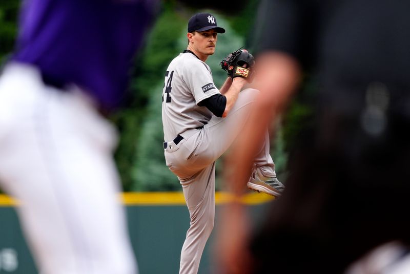May 24, 2025; Denver, Colorado, USA; New York Yankees starting pitcher Max Fried (54) delivers pitch in the first inning against the Colorado Rockies at Coors Field. Mandatory Credit: Ron Chenoy-Imagn Images