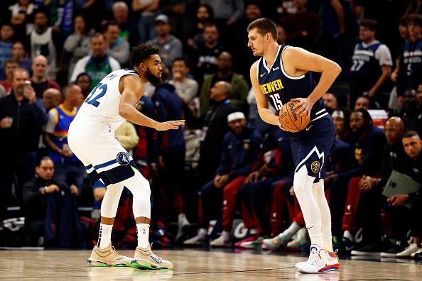 MINNEAPOLIS, MINNESOTA - NOVEMBER 01: Nikola Jokic #15 of the Denver Nuggets dribbles the ball while Karl-Anthony Towns #32 of the Minnesota Timberwolves defends in the first quarter at Target Center on November 01, 2023 in Minneapolis, Minnesota. The Timberwolves defeated the Nuggets 110-89. NOTE TO USER: User expressly acknowledges and agrees that, by downloading and or using this photograph, User is consenting to the terms and conditions of the Getty Images License Agreement. (Photo by David Berding/Getty Images)