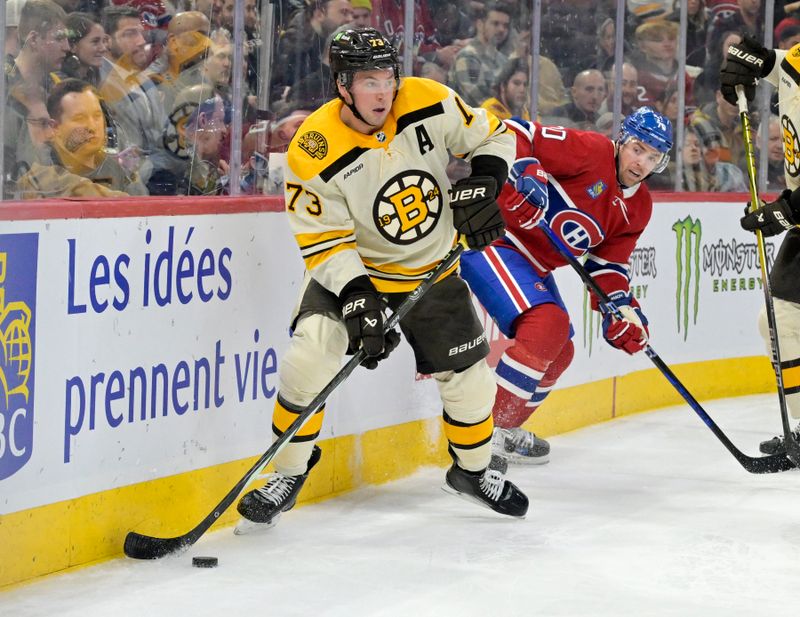 Mar 14, 2024; Montreal, Quebec, CAN; Boston Bruins defenseman Charlie McAvoy (73) takes the puck away from  Montreal Canadiens forward Tanner Pearson (70) during the second period at the Bell Centre. Mandatory Credit: Eric Bolte-USA TODAY Sports