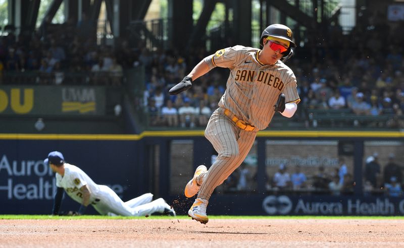 Aug 27, 2023; Milwaukee, Wisconsin, USA; San Diego Padres second baseman Ha-Seong Kim (7) runs from first to third base against the Milwaukee Brewers in the first inning at American Family Field. Mandatory Credit: Michael McLoone-USA TODAY Sports