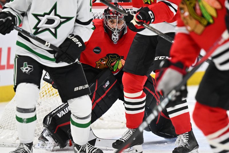 Jan 13, 2024; Chicago, Illinois, USA;  Chicago Blackhawks goaltender Petr Mrazek (34) keeps his eyes on the puck through traffic in the second period against the Dallas Stars at United Center. Mandatory Credit: Jamie Sabau-USA TODAY Sports