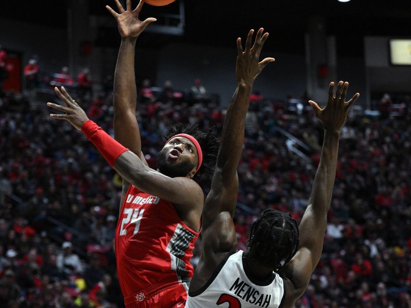 Jan 14, 2023; San Diego, California, USA; New Mexico Lobos forward Morris Udeze (24) shoots the ball over San Diego State Aztecs forward Nathan Mensah (31) during the second half at Viejas Arena. Mandatory Credit: Orlando Ramirez-USA TODAY Sports