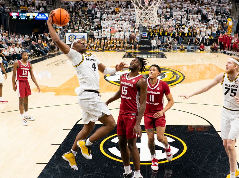 Jan 31, 2024; Columbia, Missouri, USA; Missouri Tigers guard Curt Lewis (4) shoots against Arkansas Razorbacks forward Makhi Mitchell (15) and Jalen Graham (11)\ during the second half at Mizzou Arena. Mandatory Credit: Jay Biggerstaff-USA TODAY Sports