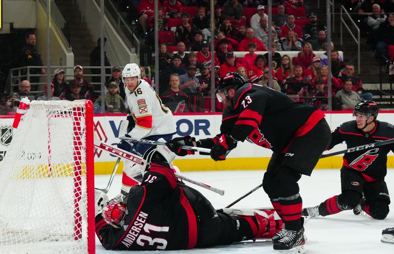 Mar 14, 2024; Raleigh, North Carolina, USA; Carolina Hurricanes goaltender Frederik Andersen (31) stops the scoring attempt by Florida Panthers center Aleksander Barkov (16) during the second period at PNC Arena. Mandatory Credit: James Guillory-USA TODAY Sports