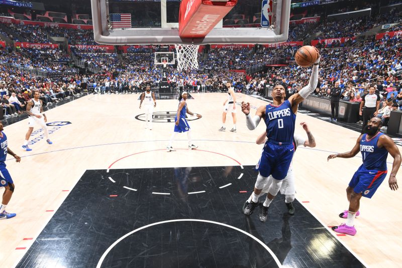 LOS ANGELES, CA - APRIL 21: Russell Westbrook #0 of the LA Clippers rebounds the ball during the game against the Dallas Mavericks during the 2024 NBA Playoffs on April 21, 2024 at Crypto.Com Arena in Los Angeles, California. NOTE TO USER: User expressly acknowledges and agrees that, by downloading and/or using this Photograph, user is consenting to the terms and conditions of the Getty Images License Agreement. Mandatory Copyright Notice: Copyright 2024 NBAE (Photo by Andrew D. Bernstein/NBAE via Getty Images)