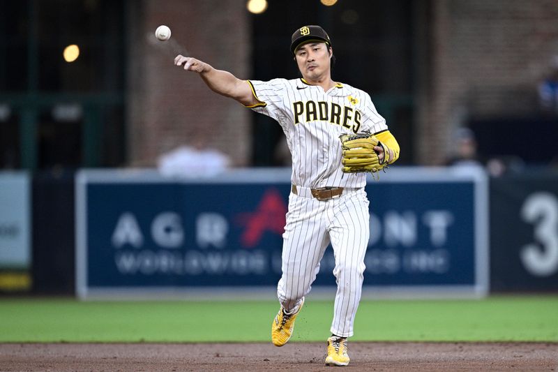 Aug 13, 2024; San Diego, California, USA; San Diego Padres shortstop Ha-Seong Kim (7) throws to first base against the Pittsburgh Pirates during the third inning at Petco Park. Mandatory Credit: Orlando Ramirez-USA TODAY Sports