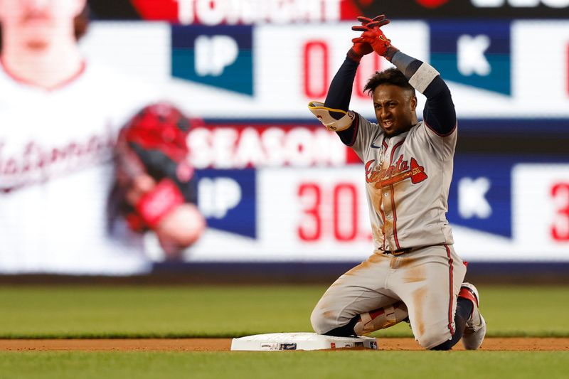 Jun 6, 2024; Washington, District of Columbia, USA; Atlanta Braves second baseman Ozzie Albies (1) gestures to his dugout from second base after hitting a double against the Washington Nationals during the eighth inning at Nationals Park. Mandatory Credit: Geoff Burke-USA TODAY Sports