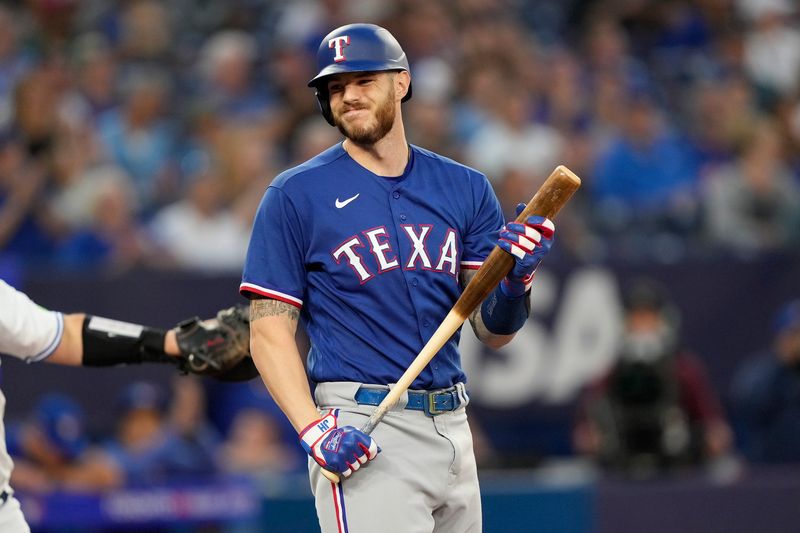 Sep 11, 2023; Toronto, Ontario, CAN; Texas Rangers designated hitter Jonah Heim (28) reacts after striking out against the Toronto Blue Jays during the second inning at Rogers Centre. Mandatory Credit: John E. Sokolowski-USA TODAY Sports