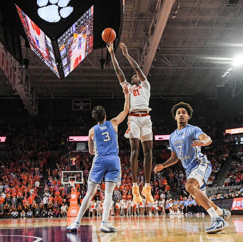 Jan 6, 2024; Clemson, South Carolina, USA; Clemson sophomore forward Chauncey Wiggins (21) shoots the ball near University of North Carolina guard Seth Trimble (7) during the second half at Littlejohn Coliseum. Mandatory Credit: Ken Ruinard-USA TODAY Sports