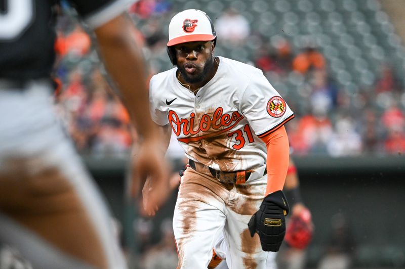 Sep 4, 2024; Baltimore, Maryland, USA;  Baltimore Orioles outfielder Cedric Mullins (31) attempts to advance to third base on a fly ball during the second inning against the Chicago White Sox at Oriole Park at Camden Yards. Mandatory Credit: Tommy Gilligan -Imagn Images
