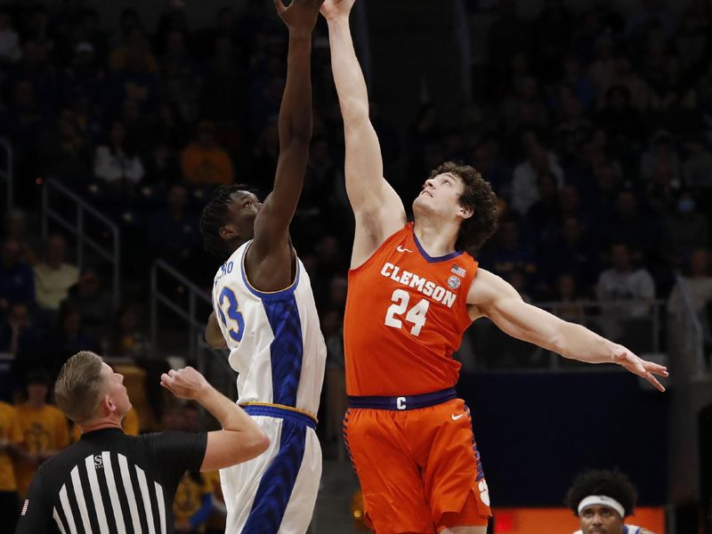 Jan 7, 2023; Pittsburgh, Pennsylvania, USA;  Pittsburgh Panthers center Federiko Federiko (33) and Clemson Tigers center PJ Hall (24) reach for the opening tip off during the first half at the Petersen Events Center. Mandatory Credit: Charles LeClaire-USA TODAY Sports