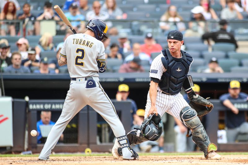 Sep 10, 2023; Bronx, New York, USA;  New York Yankees catcher Ben Rortvedt (38) looks for the ball after it drops behind Milwaukee Brewers second baseman Brice Turang (2) in the second inning at Yankee Stadium. Mandatory Credit: Wendell Cruz-USA TODAY Sports