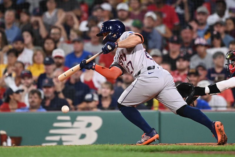 Aug 9, 2024; Boston, Massachusetts, USA; Houston Astros second baseman Jose Altuve (27) bunts against the Boston Red Sox during the fifth inning at Fenway Park. Mandatory Credit: Eric Canha-USA TODAY Sports